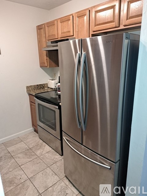 A kitchen with a stainless steel refrigerator and oven.