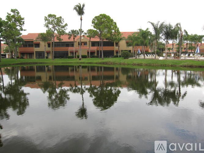 A building is reflected in the water in front of it.