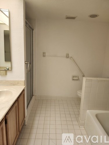 A bathroom with a white tub and sink.