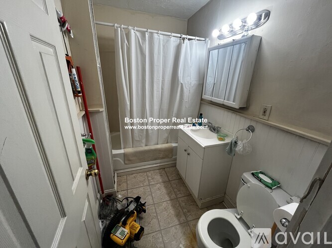 A bathroom with a toilet, sink, and shower.