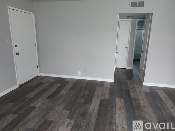 A kitchen with white cabinets and a white refrigerator.