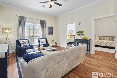 A living room with a beige couch and blue chairs.