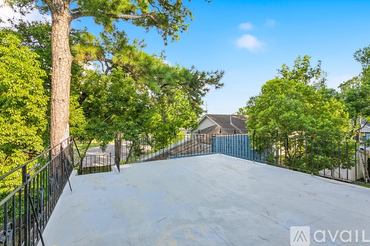 A skate park with a ramp surrounded by trees and a fence.