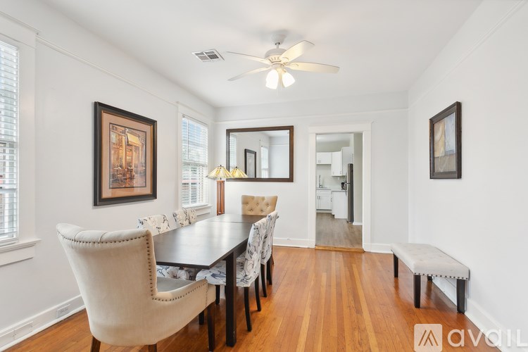 A dining room with a wooden table and chairs.