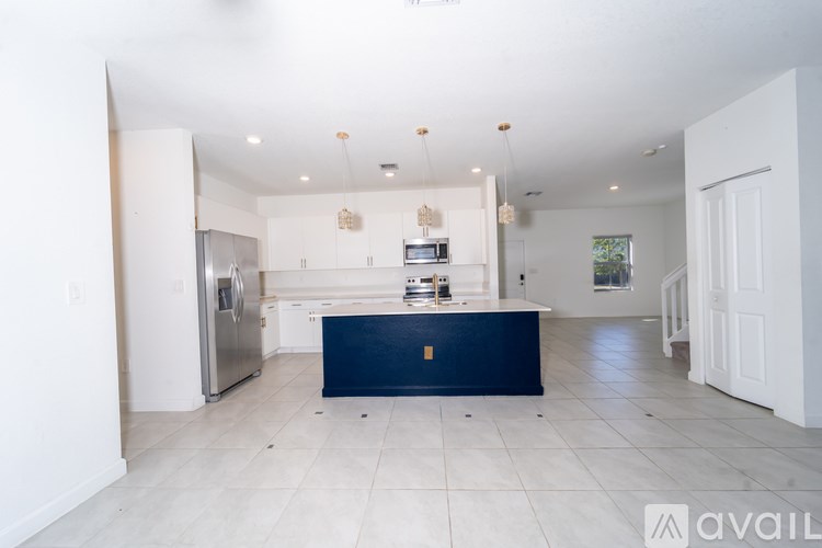 A kitchen with a blue island in the middle.