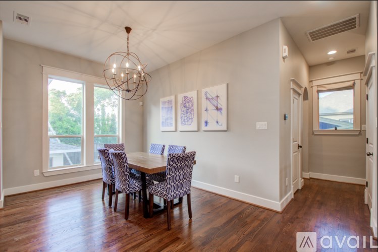 A dining room with a wooden table and chairs.