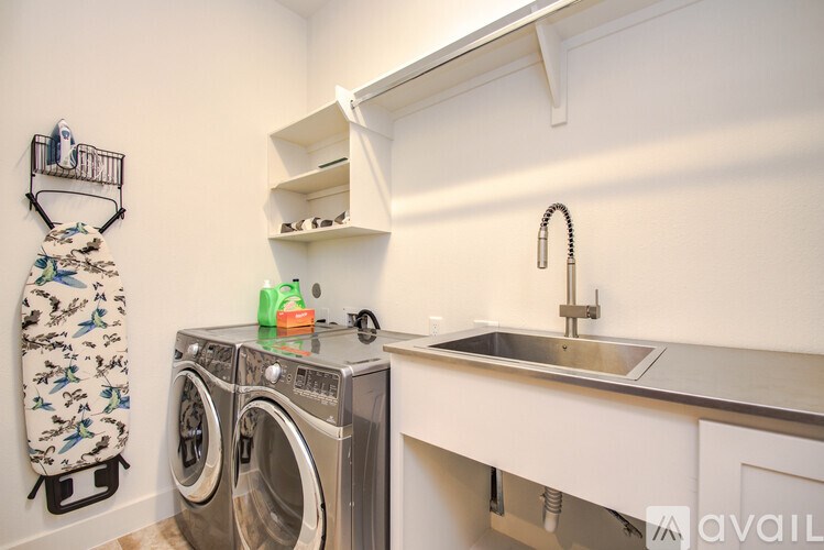 A small laundry room with a washer and dryer.
