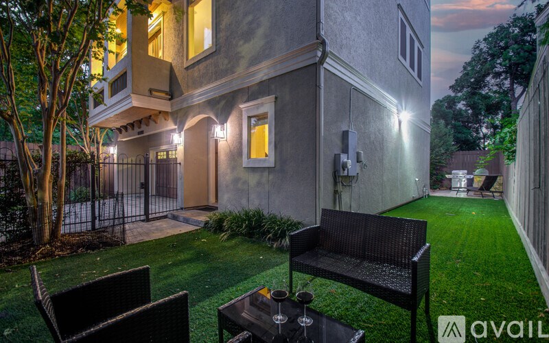 A patio with a table and chairs is set up outside a house.