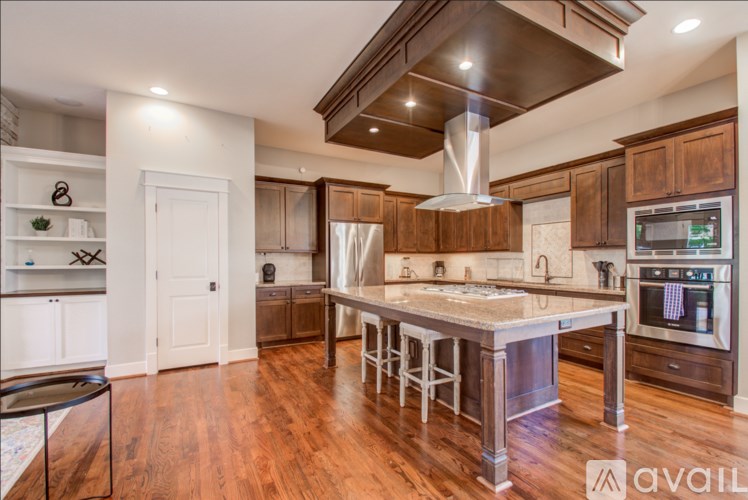 A kitchen with wooden cabinets and a center island.
