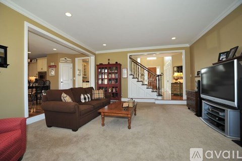 A living room with a brown couch and a television.