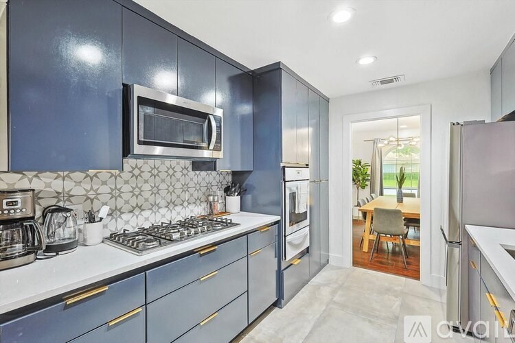 A kitchen with blue cabinets and a white countertop.