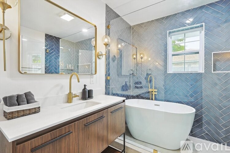A bathroom with a white sink and a white bathtub.