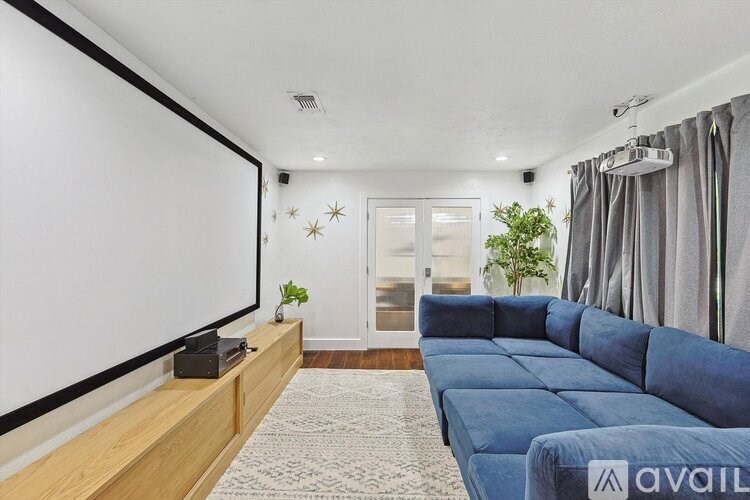 A living room with a blue couch and a television.
