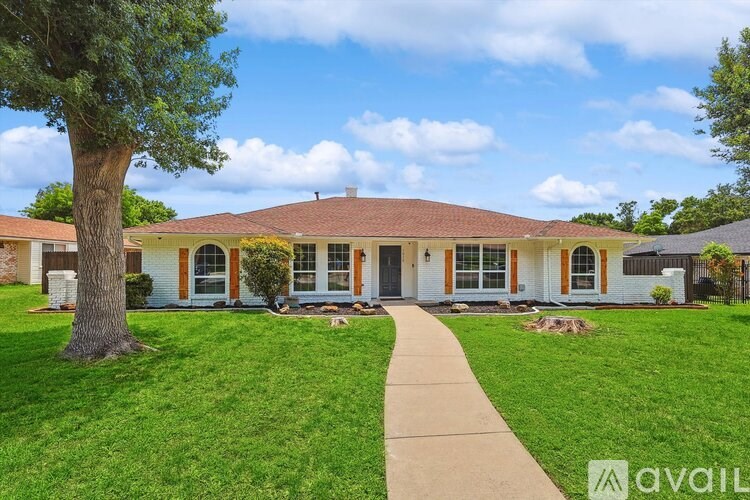 A house with a tree in front of it.