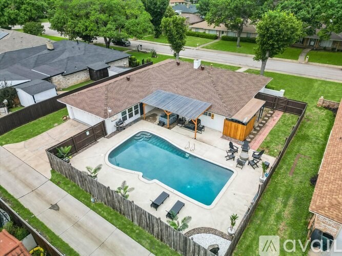 A backyard with a pool and a deck.