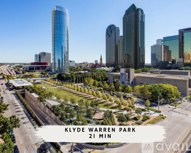 A cityscape with a sign that reads "KLYDE WARREN PARK 21 MIN".
