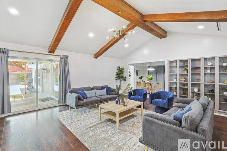 A living room with a grey couch and a wooden coffee table.