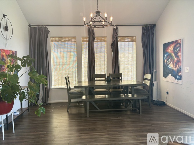 A dining room with a table and chairs.