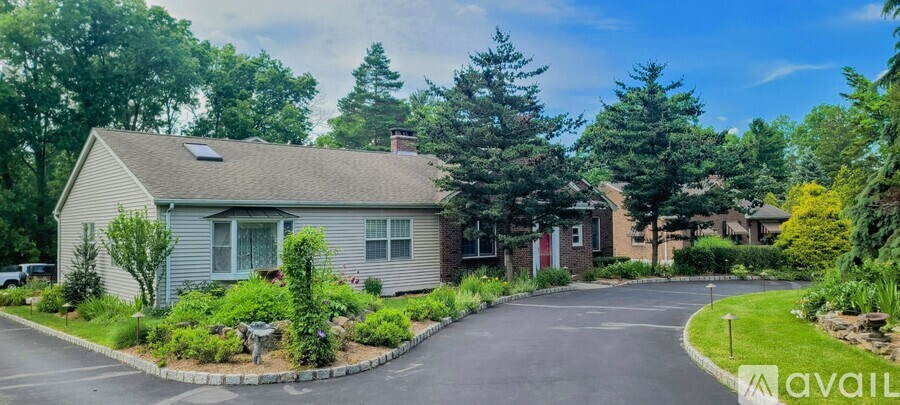 A house with a driveway and a sign that says "available".