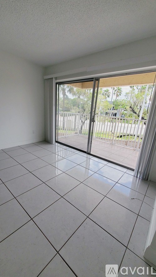 A room with a sliding glass door leading to a backyard.