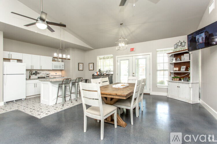 A kitchen with a dining table and chairs.