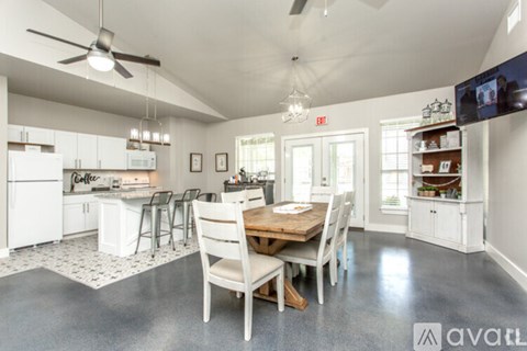A kitchen with a dining table and chairs.
