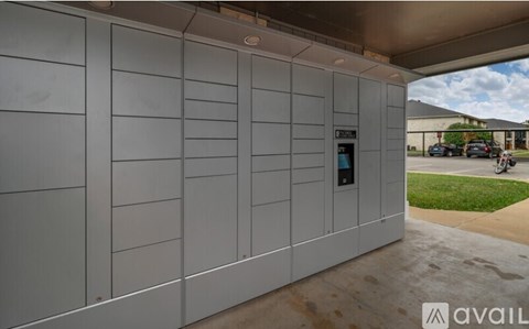 A modern building with a grey facade and a glass door.