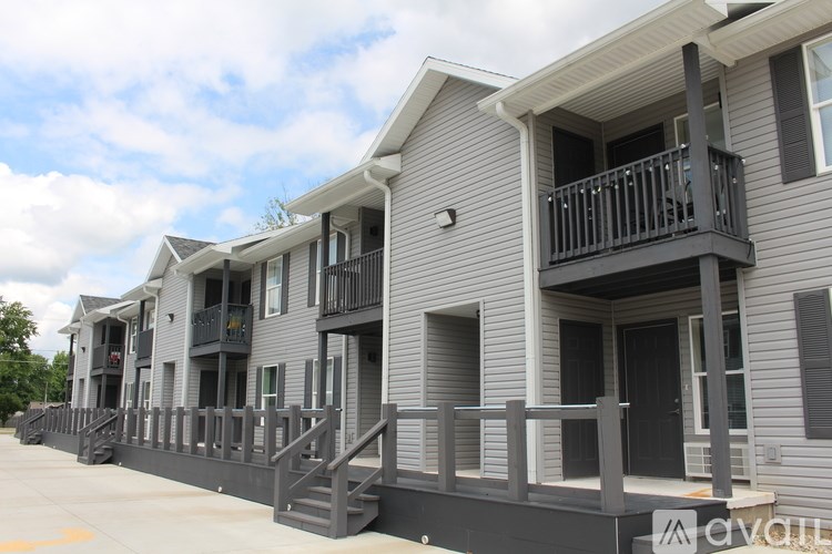 A row of houses with balconies and stairs leading to the doors.