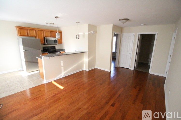 A kitchen with wooden floors and white walls.