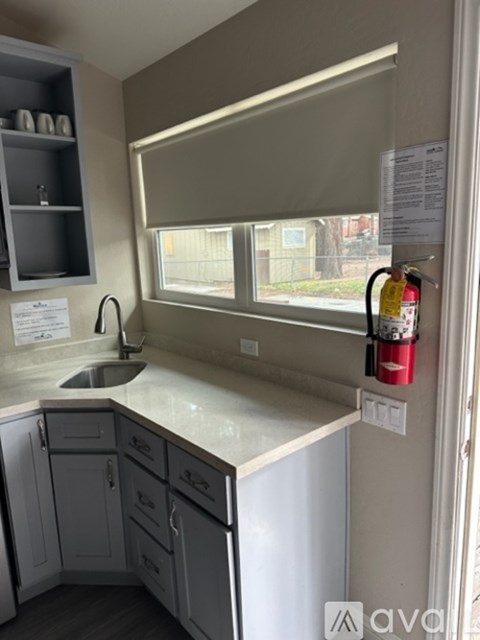 A kitchen with a sink and a window.