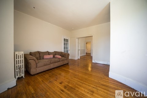 A room with a couch and a radiator.