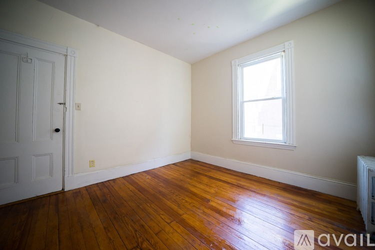 A room with a wooden floor and a window.