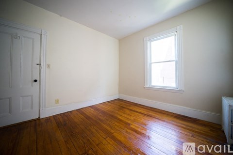 A room with a wooden floor and a window.