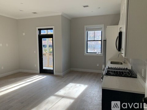 A kitchen with a window and a door leading outside.
