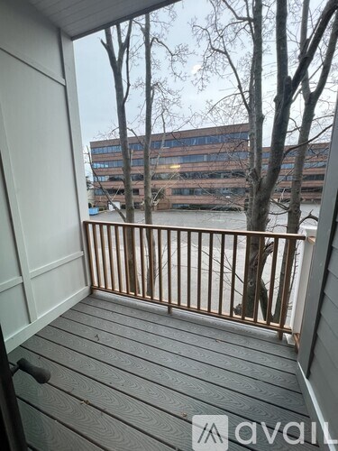 A balcony with a view of a river and buildings.