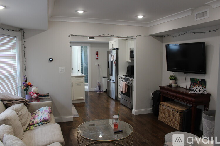 A living room with a couch, coffee table, and television.