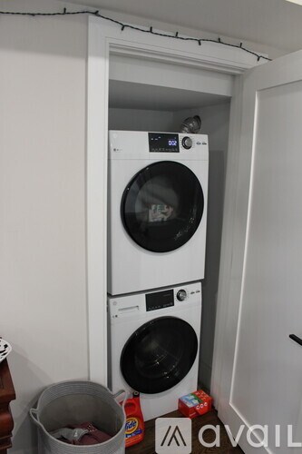 A white washing machine and dryer in a small laundry room.