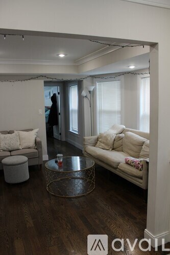A living room with a white couch and a coffee table.