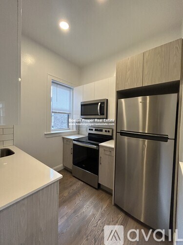 A kitchen with a stainless steel refrigerator and a white countertop.