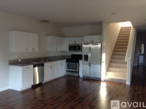 A kitchen with white cabinets and a stainless steel dishwasher.