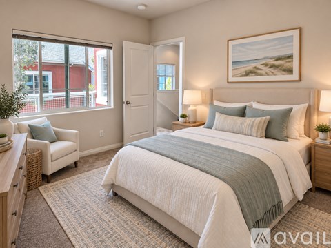 A bedroom with a large bed and a painting on the wall.