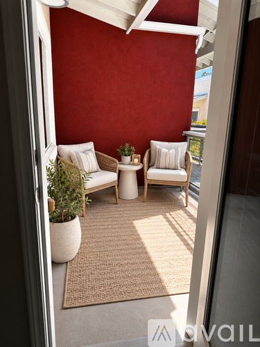 A living room with a red wall and a white sofa.