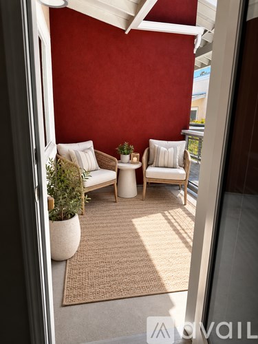 A living room with a red wall and a white sofa.