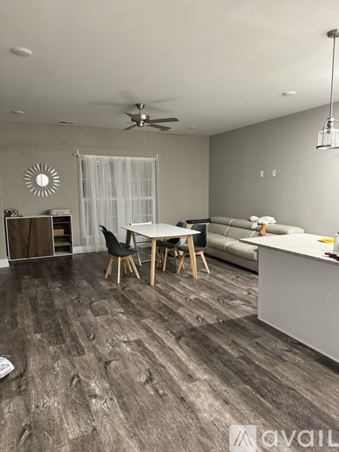 A living room with a dining table and chairs.