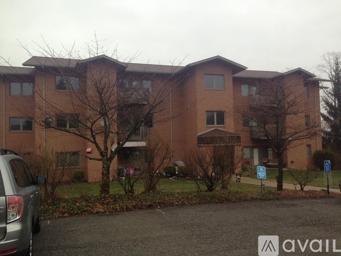 Apartment building with a car parked in front.