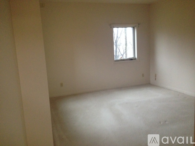 A room with a window and a white floor.