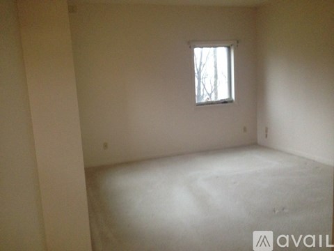 A room with a window and a white floor.