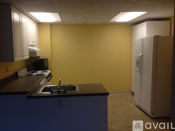 A kitchen with a sink and a refrigerator.
