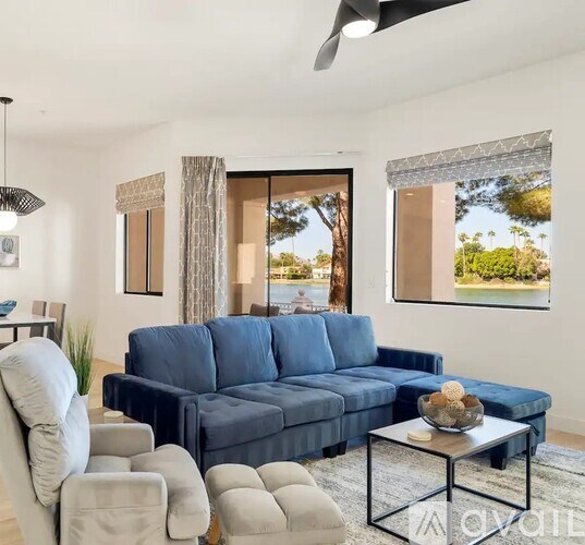 A living room with a blue couch and a coffee table.