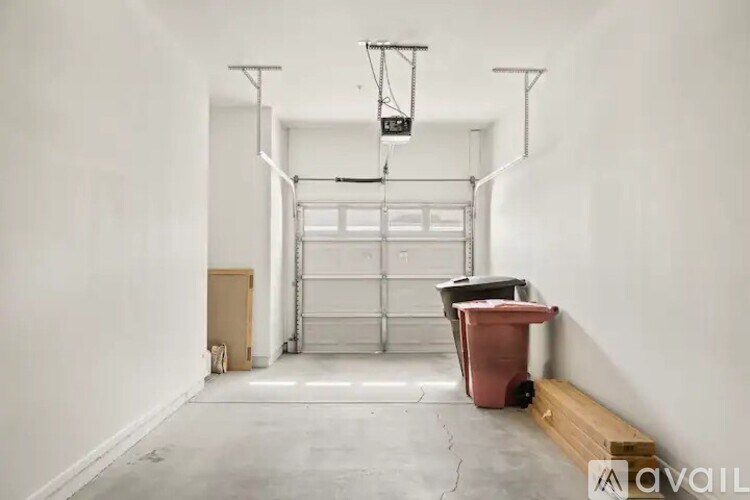 A room with a white wall and a garage door opener.